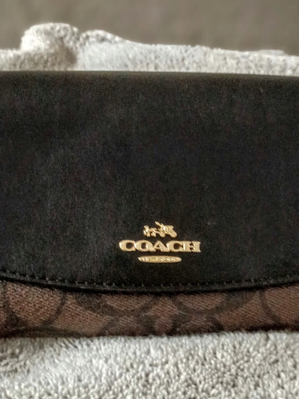 This Coach Signature PVC Slim Envelope Wallet features a brown monogram canvas b